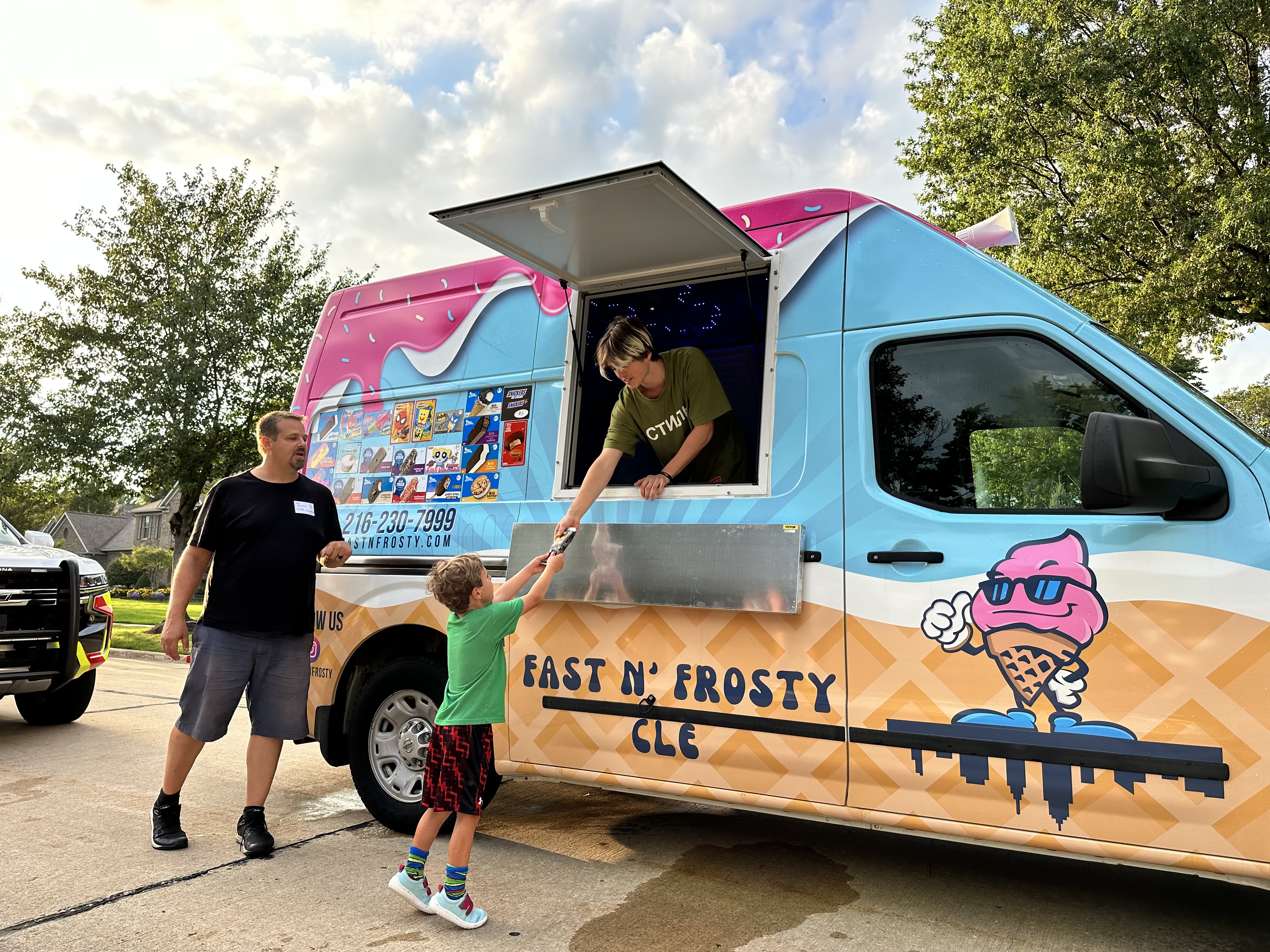 Fast N' Frosty truck serving a family in the neighborhood